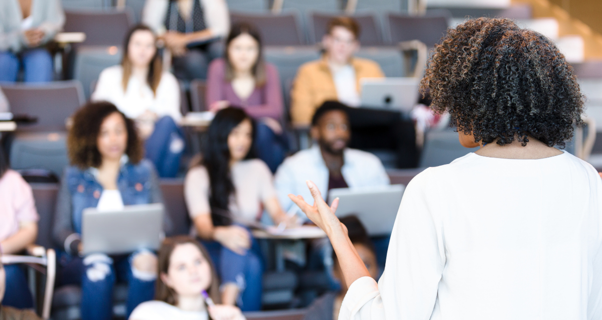 Professor presenting to a group of students on risers.